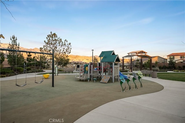 view of jungle gym featuring a mountain view