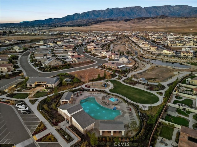 5097 Larkspur Rd, Banning, CA 92220 - aerial view of property and surrounding area featuring nearby suburban area, a mountain backdrop, and a pool area