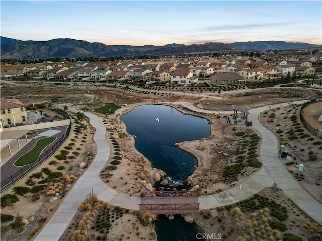 aerial view at dusk with a water and mountain view