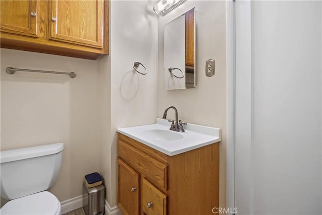 bathroom with toilet and vanity