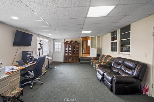 carpeted office featuring a paneled ceiling