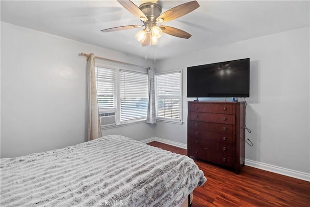 bedroom featuring dark wood-type flooring, ceiling fan, and cooling unit