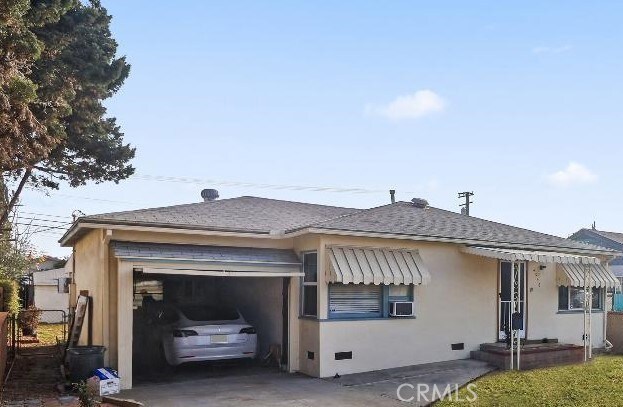 view of front of house with a garage and cooling unit