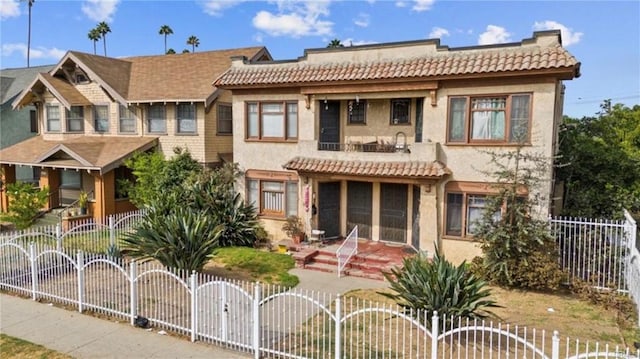 view of front of house featuring a balcony