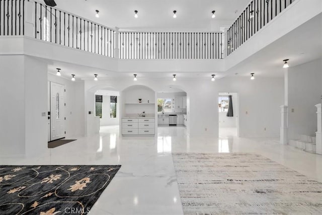 foyer entrance with a towering ceiling