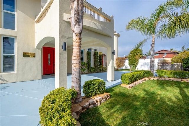 entrance to property with a lawn