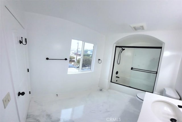 full bath featuring toilet, marble finish floor, visible vents, and bath / shower combo with glass door