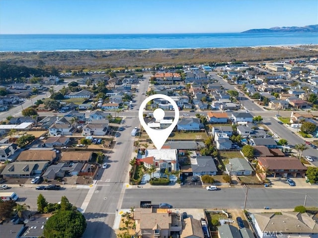 drone / aerial view featuring a water view and a residential view