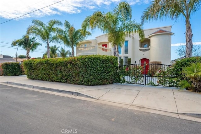 view of front of home featuring a gate and stucco siding