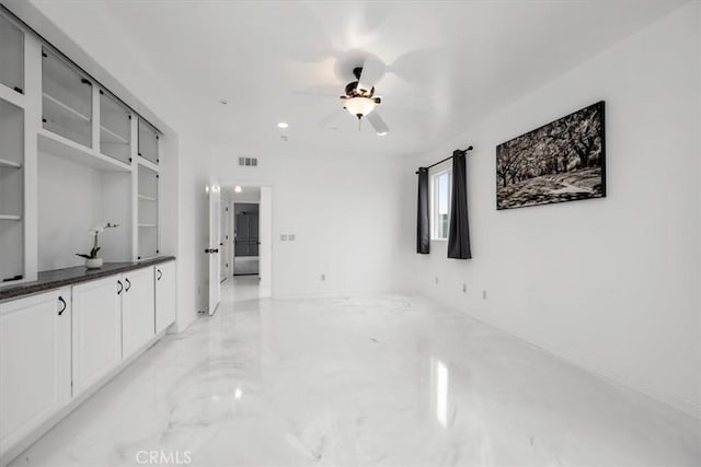 interior space featuring marble finish floor, visible vents, and ceiling fan