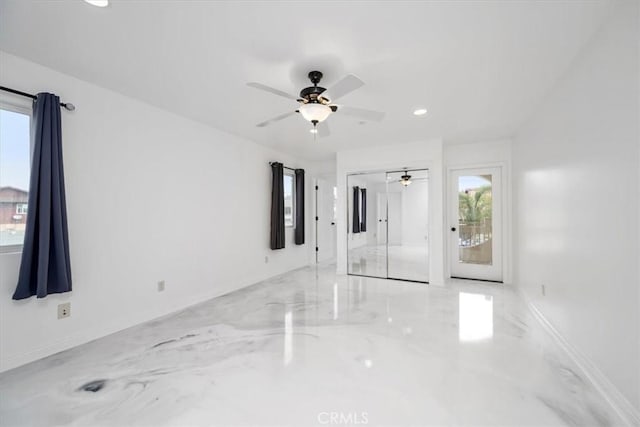 unfurnished room featuring ceiling fan and a wealth of natural light