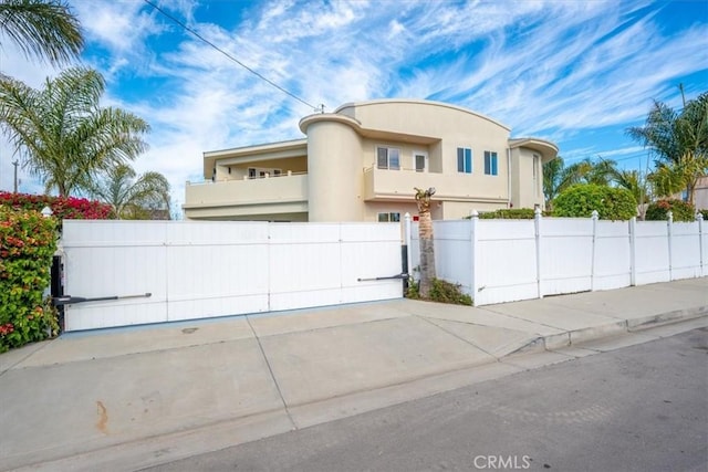 view of front of home with a fenced front yard and stucco siding