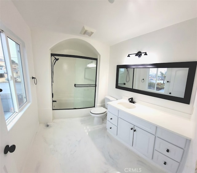 full bathroom featuring enclosed tub / shower combo, toilet, visible vents, vanity, and marble finish floor