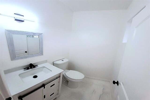 bathroom with toilet and vanity