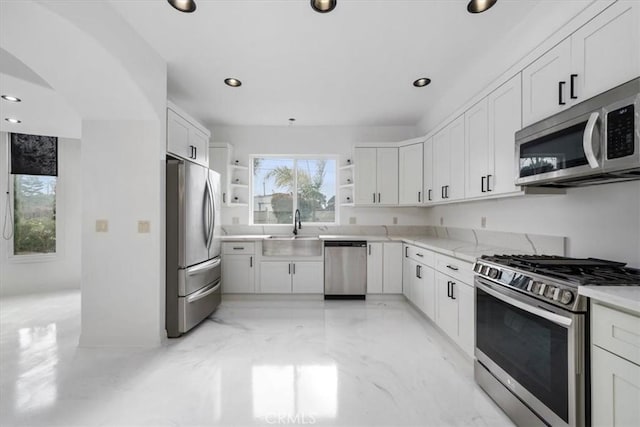 kitchen featuring stainless steel appliances, a sink, white cabinetry, marble finish floor, and open shelves