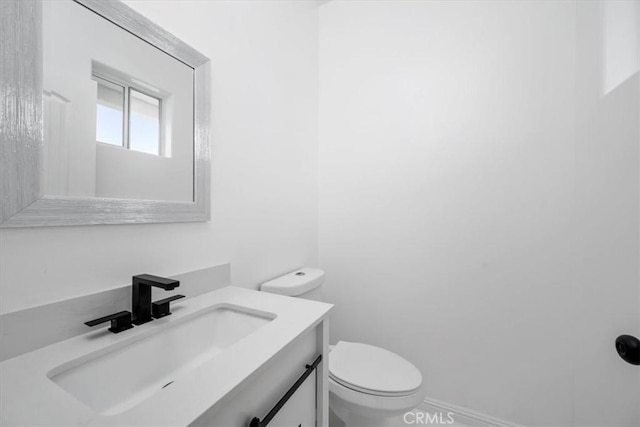 bathroom with toilet and vanity