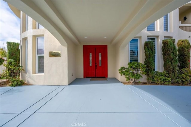 doorway to property with stucco siding