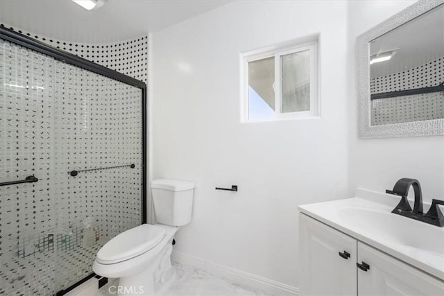 bathroom with marble finish floor, toilet, a shower stall, vanity, and baseboards