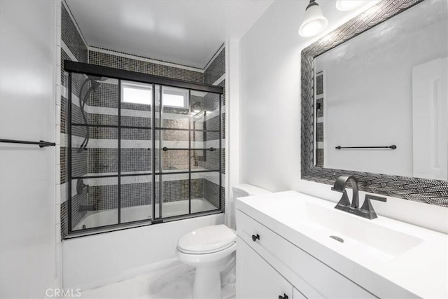 full bathroom featuring toilet, enclosed tub / shower combo, and vanity