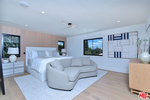 bedroom featuring light hardwood / wood-style floors and a chandelier