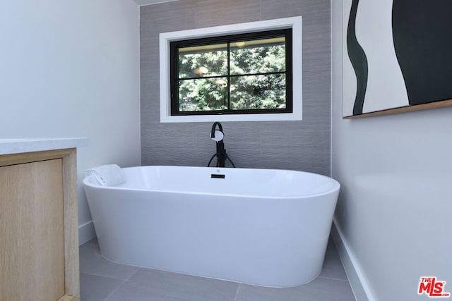 bathroom with tile patterned floors and a bathing tub