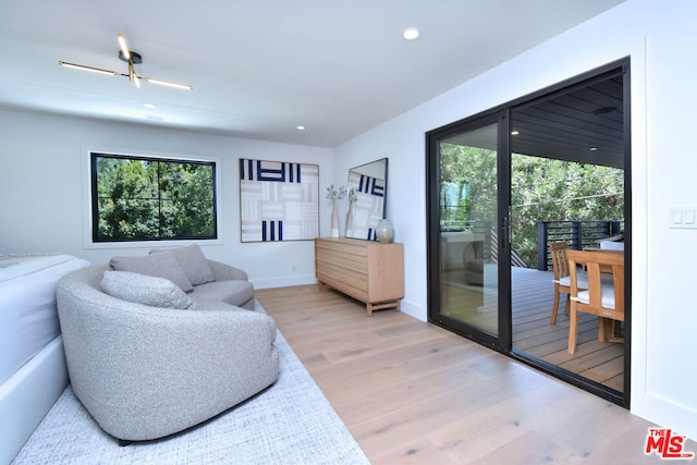 living room with ceiling fan, a wealth of natural light, and hardwood / wood-style flooring