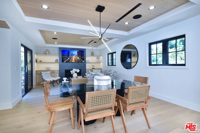 dining space featuring a raised ceiling, wood ceiling, light hardwood / wood-style floors, and a notable chandelier