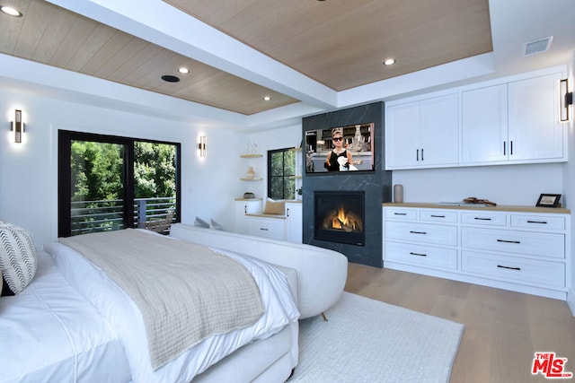 bedroom featuring a high end fireplace, wood ceiling, light hardwood / wood-style floors, access to exterior, and beam ceiling