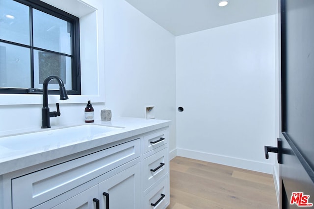 bathroom featuring vanity and hardwood / wood-style flooring