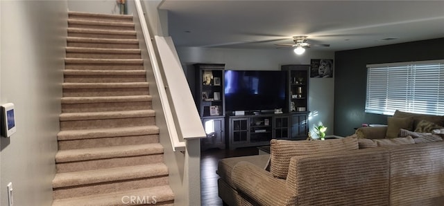 living room featuring wood-type flooring and ceiling fan