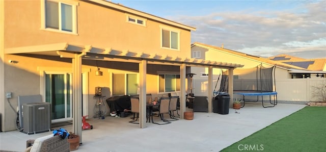 rear view of house featuring a patio, cooling unit, and a trampoline