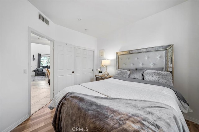 bedroom with a closet and light wood-type flooring