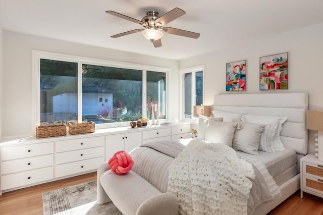 bedroom with ceiling fan and light hardwood / wood-style flooring