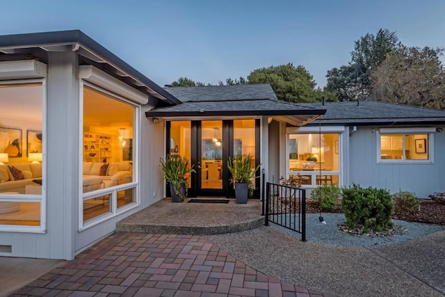 back house at dusk with a patio area