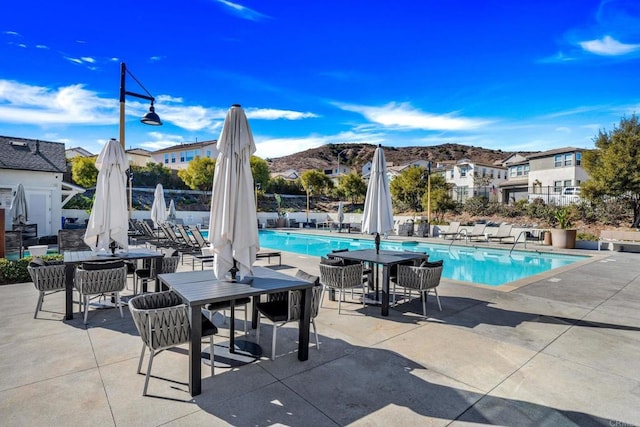 view of pool featuring a mountain view and a patio area