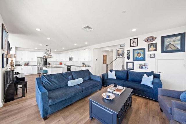 living room featuring sink and light wood-type flooring