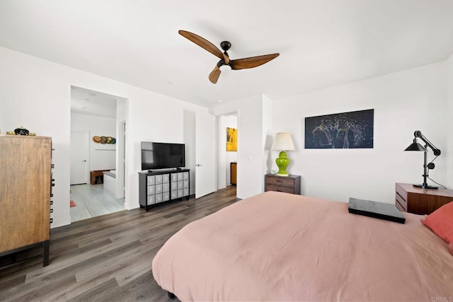 bedroom featuring dark hardwood / wood-style flooring, connected bathroom, and ceiling fan