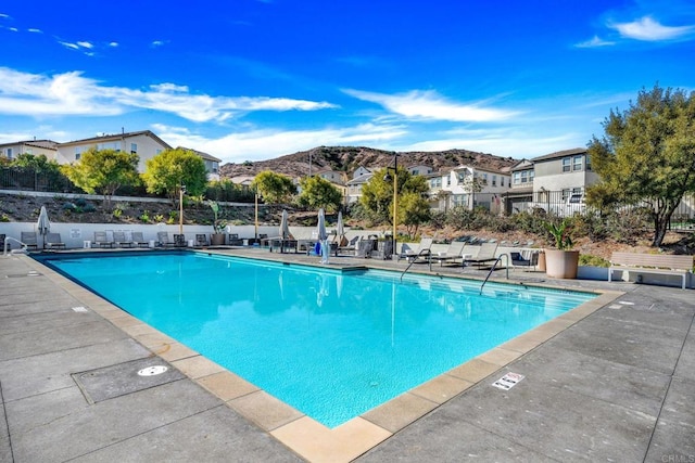 view of swimming pool featuring a mountain view and a patio