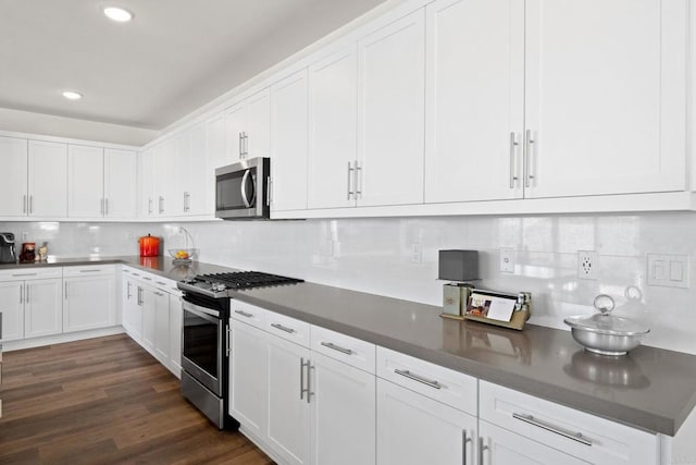 kitchen with white cabinetry, appliances with stainless steel finishes, dark wood-type flooring, and decorative backsplash