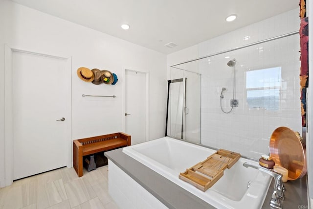 bathroom with tile patterned floors and plus walk in shower