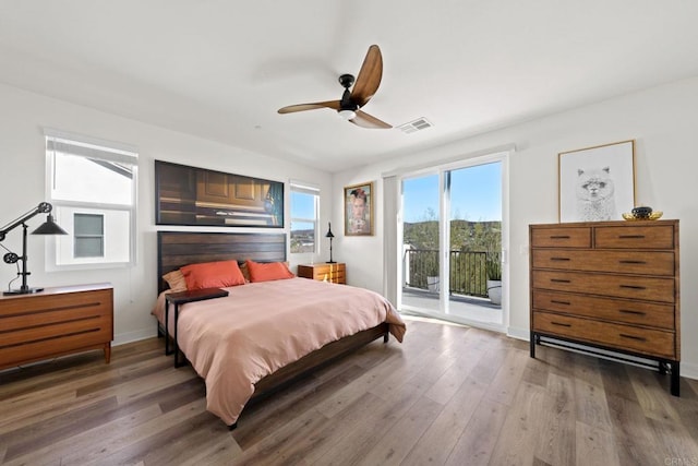 bedroom featuring ceiling fan, hardwood / wood-style floors, and access to outside