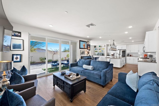 living room featuring sink and light wood-type flooring