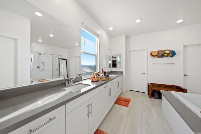 bathroom with vanity and a shower with shower door