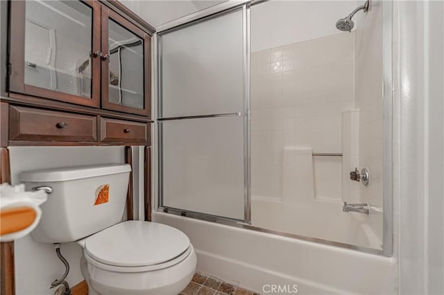full bath featuring toilet and bath / shower combo with glass door