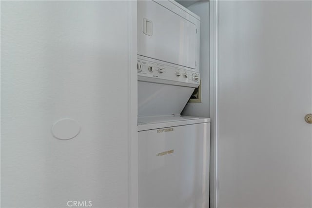 laundry area featuring stacked washing maching and dryer