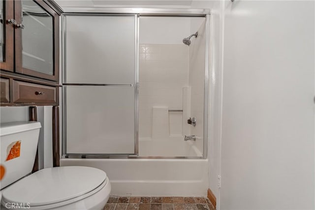 bathroom with toilet and enclosed tub / shower combo