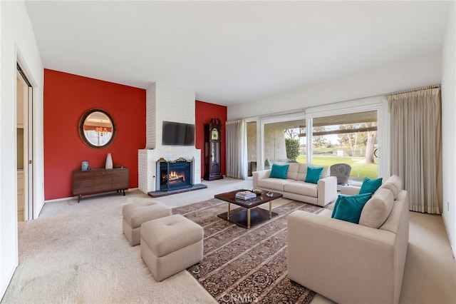 carpeted living room with a brick fireplace