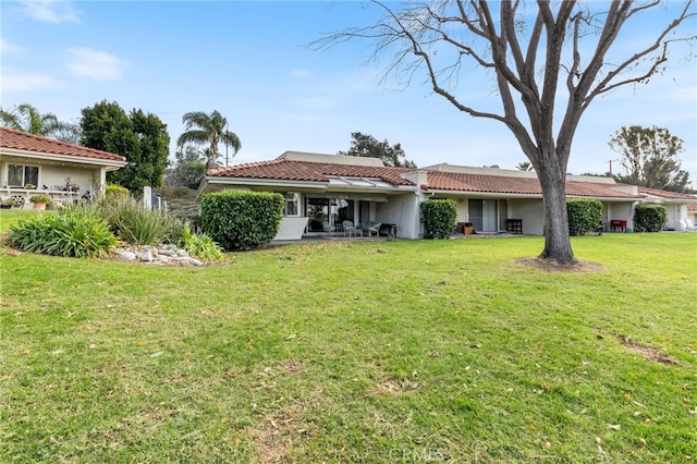 rear view of property with a lawn