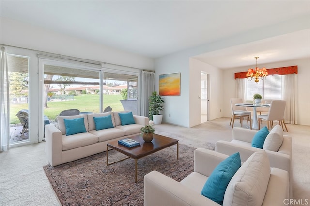 living room with carpet flooring and a notable chandelier