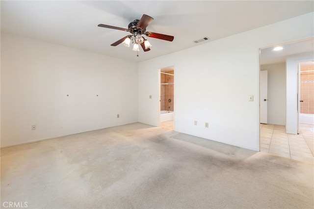 carpeted spare room with ceiling fan